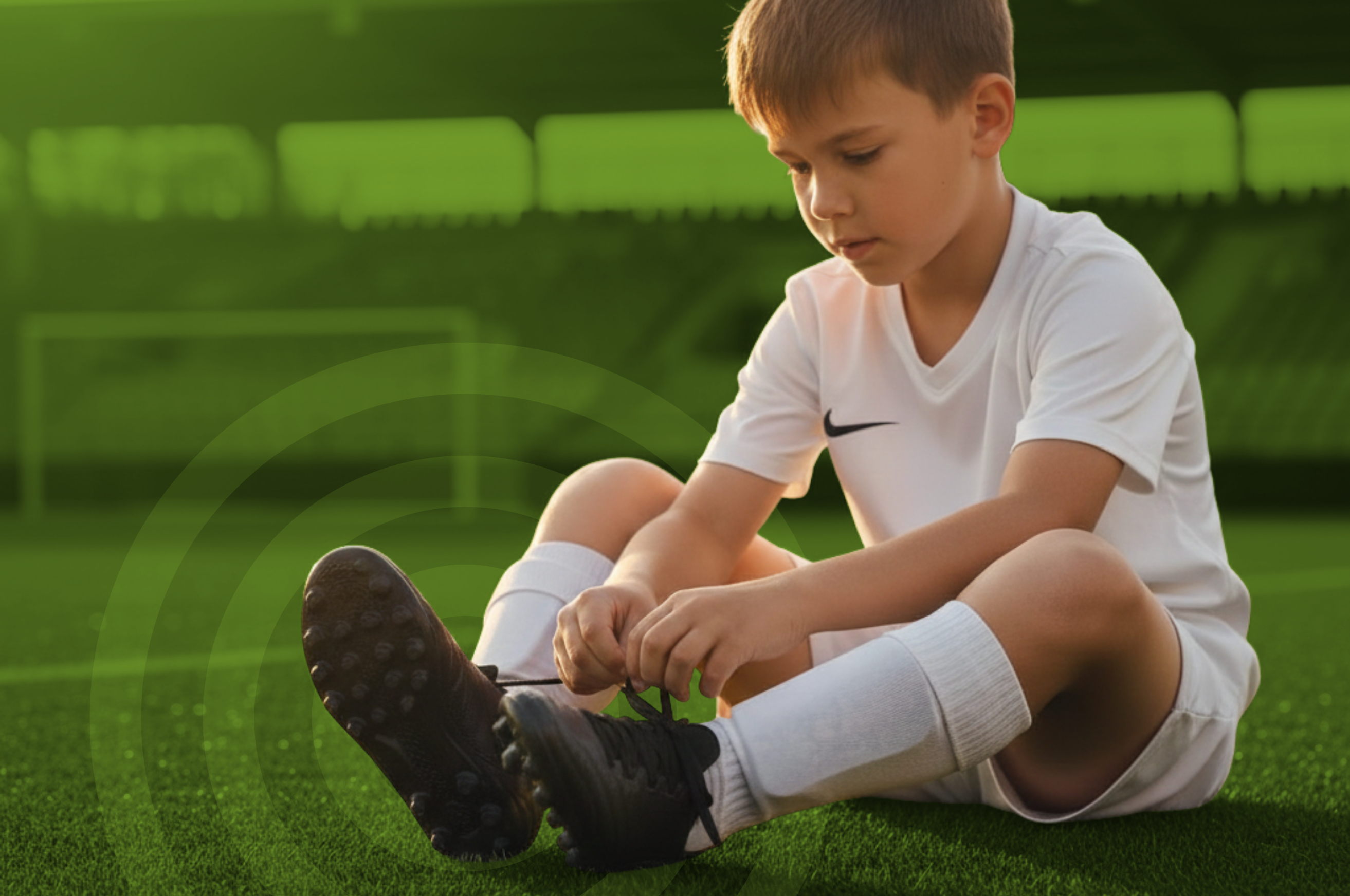 Niño con botas de fútbol de césped artificial 